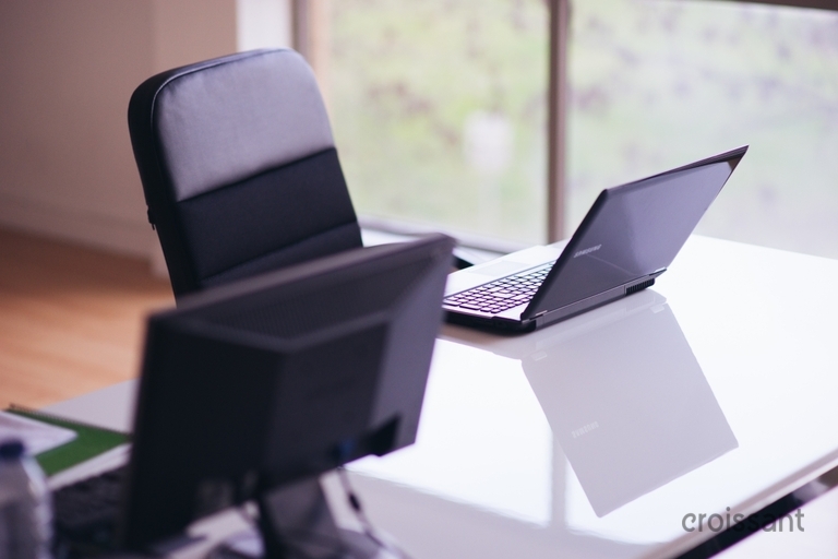 a laptop computer sitting on top of a table