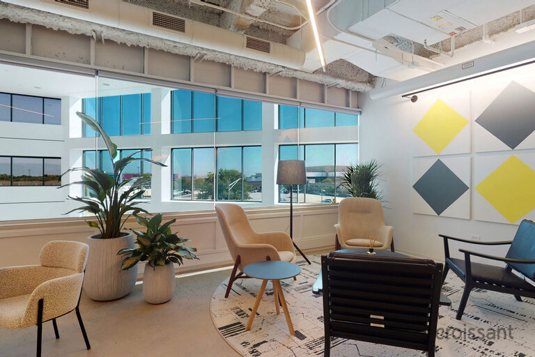 a room filled with furniture and a table in front of a building