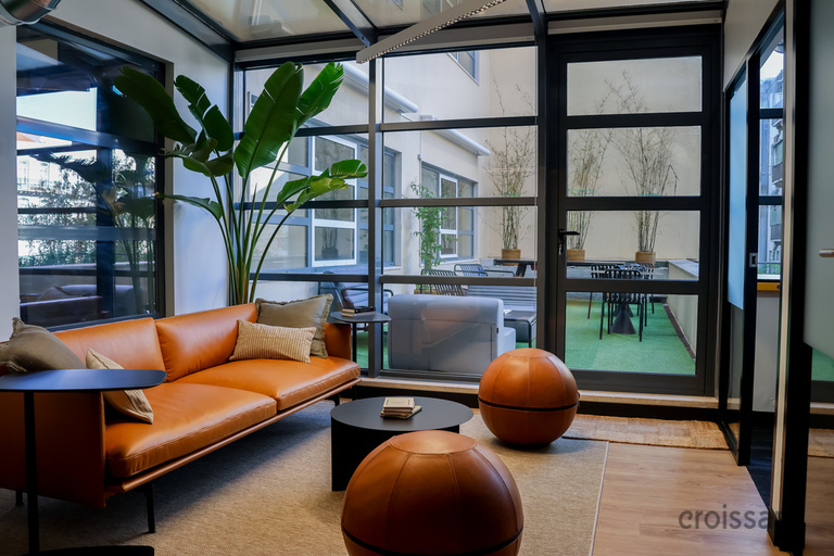 a living room filled with furniture and a large window