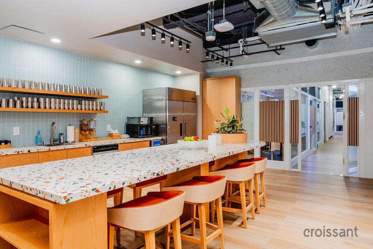 a kitchen with a counter and stools