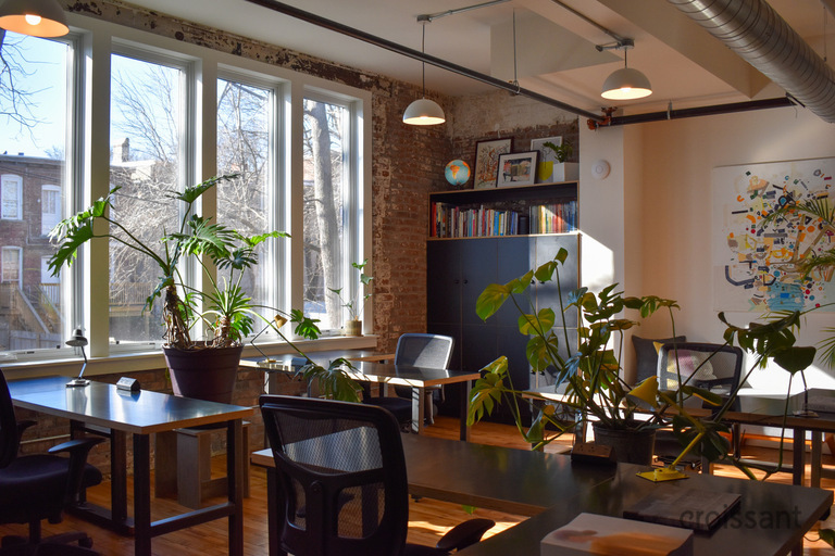a living room filled with furniture and vase of flowers on a table