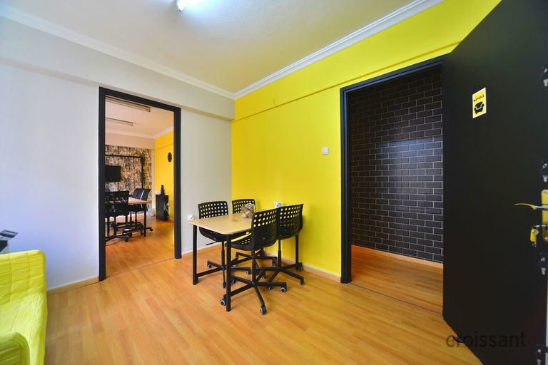 a living room filled with furniture on top of a hard wood floor