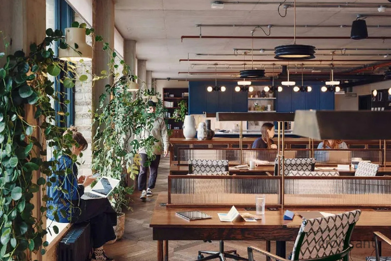 a group of people sitting at a table in a library