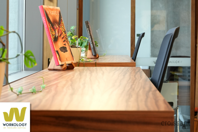 a desk with a laptop computer sitting on top of a wooden table