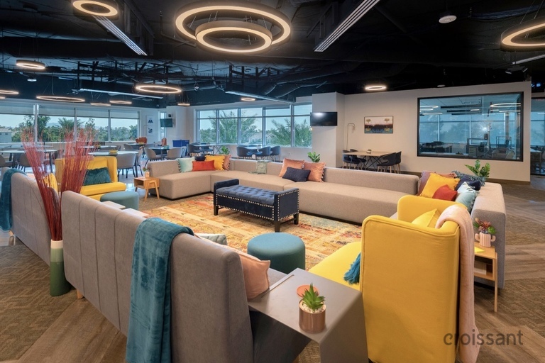 a living room filled with furniture and a large window