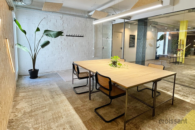 a room filled with furniture and a table in front of a building