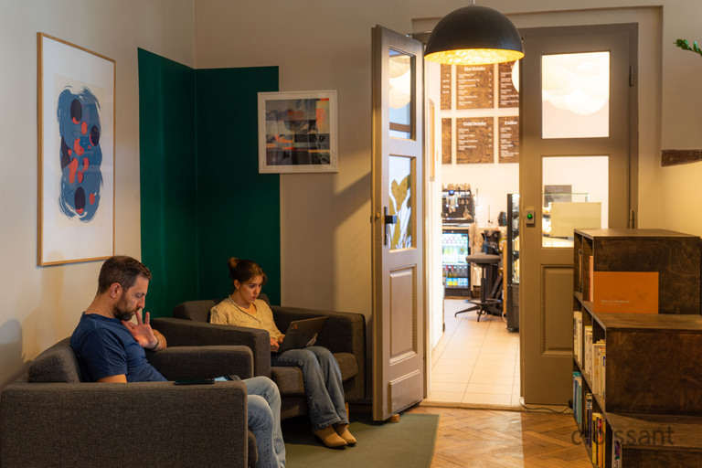 a man and woman sitting in chairs in a room with a door open