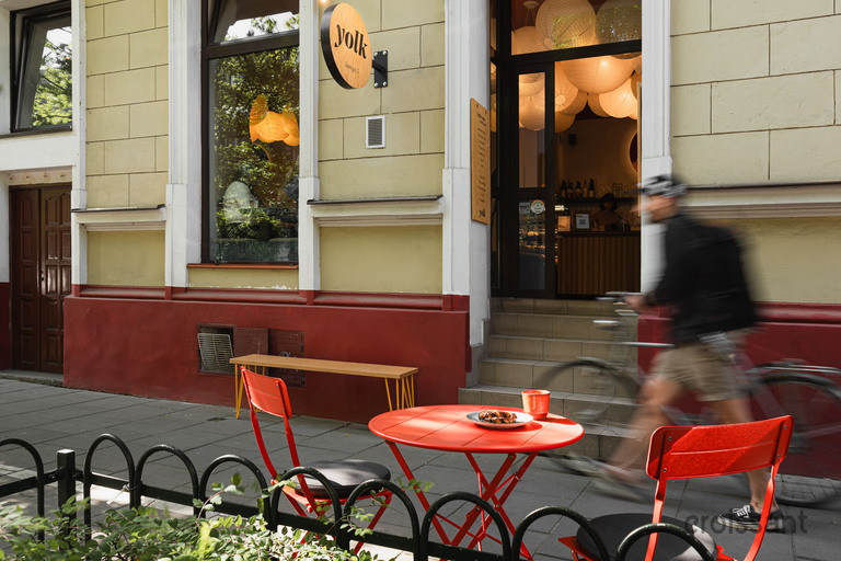 a man riding a bicycle in front of a building