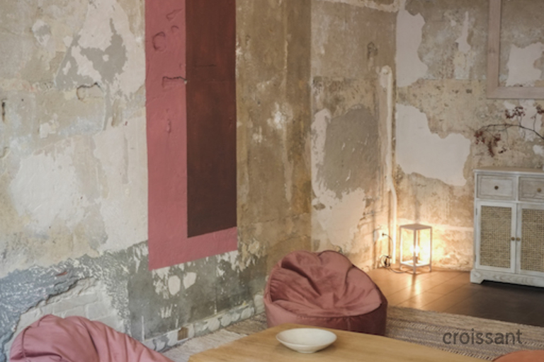 a bedroom with a building in the background