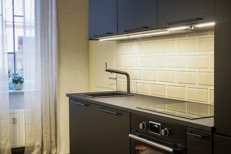 a stove top oven sitting inside of a kitchen