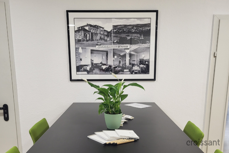 a room filled with furniture and vase of flowers on a table